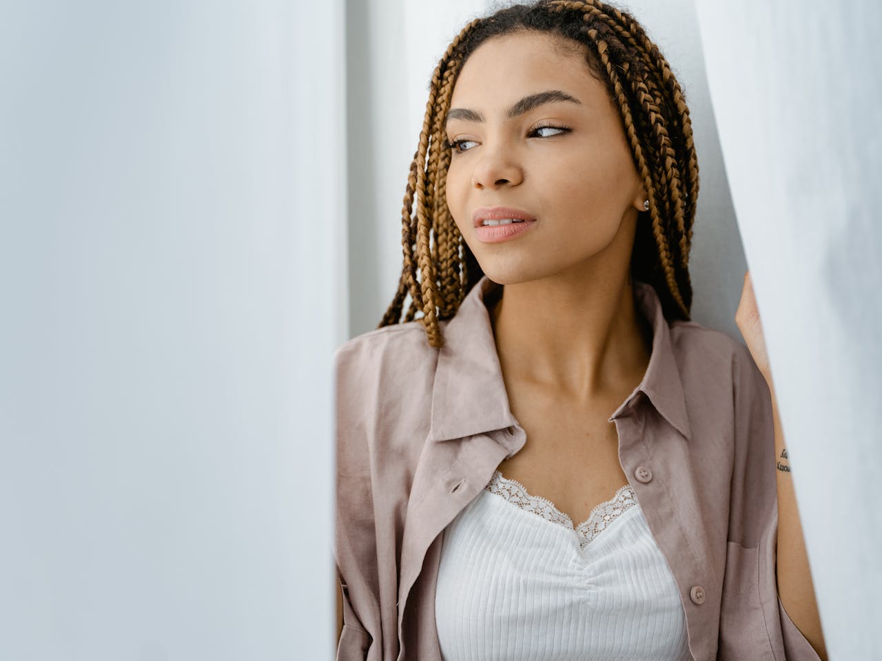 portfolio-img-03 Stylish young woman with braided hair posing indoors, exuding confidence and elegance.